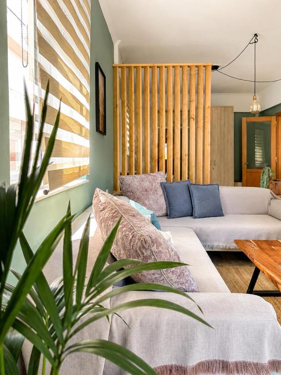 a living room with a couch and a table at Blossom Apartment Kos in Ampavris