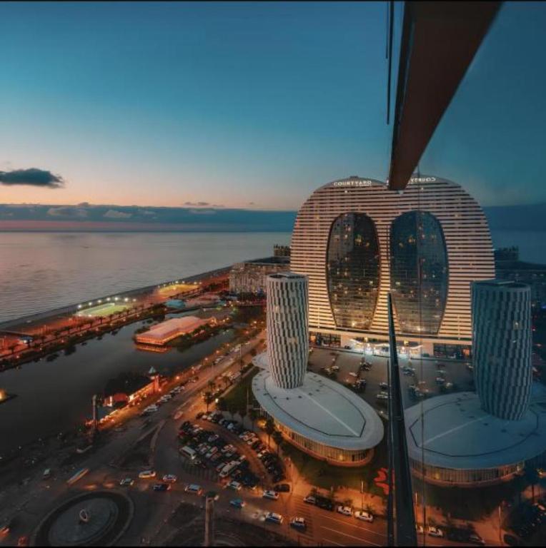 an aerial view of a city with a building at Panorama ORBI CITY LUXURY in Batumi