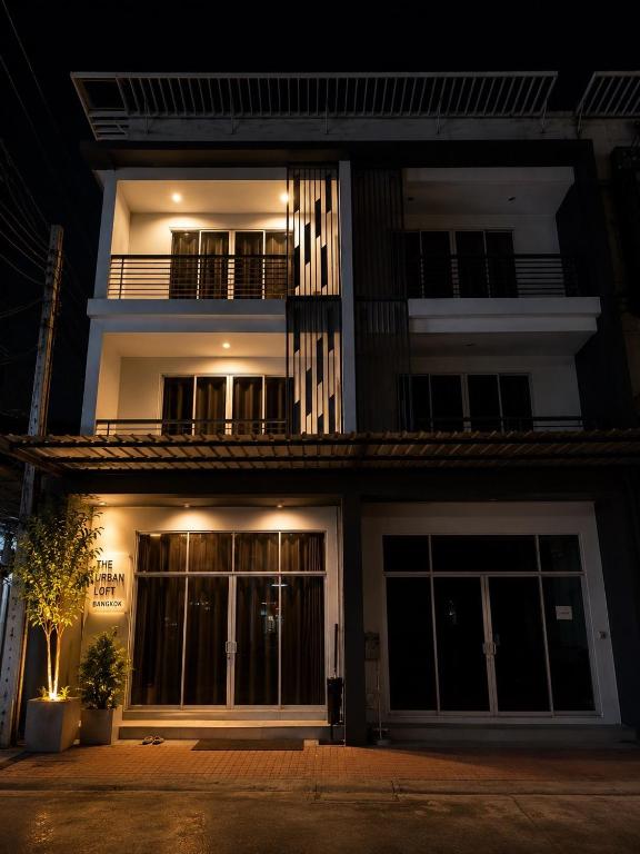 a night view of a building with a balcony at Sena living Tiwanon Rd in Ban Bang Kradi (1)