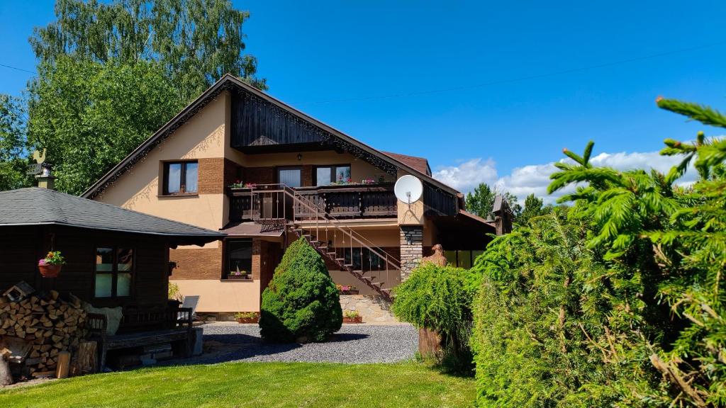 a house with a porch and a balcony at Privát Prima in Liptovský Ján