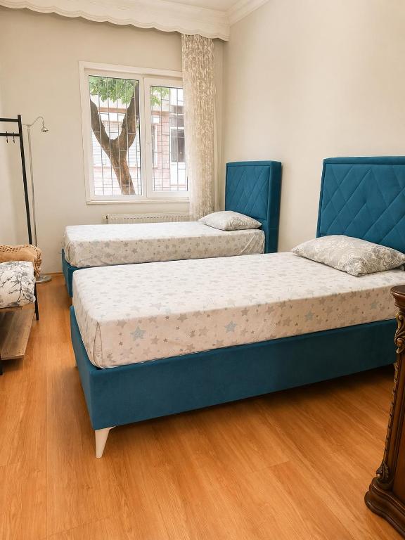a room with three beds and a window at Twin Double X2 Room in Istanbul