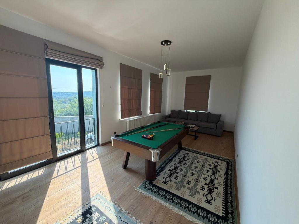 a room with a pool table and a large window at Mega Life in Khashmi