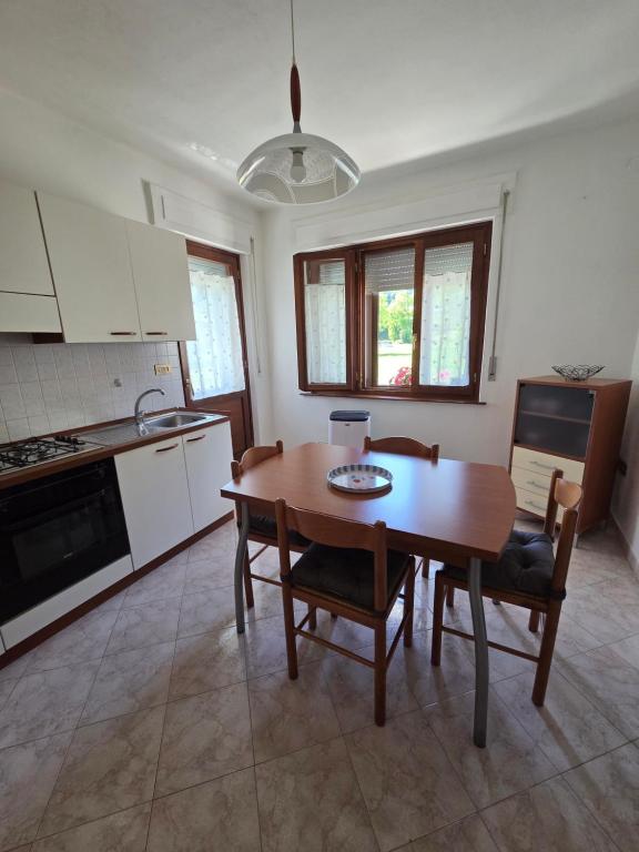 a kitchen and dining room with a table and chairs at Piccola Stella in Moggio Udinese
