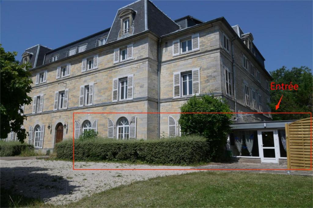 a large brick building with a red arrow pointing to a building at L'Ecrin du Chalet d'Arguel in Pugey