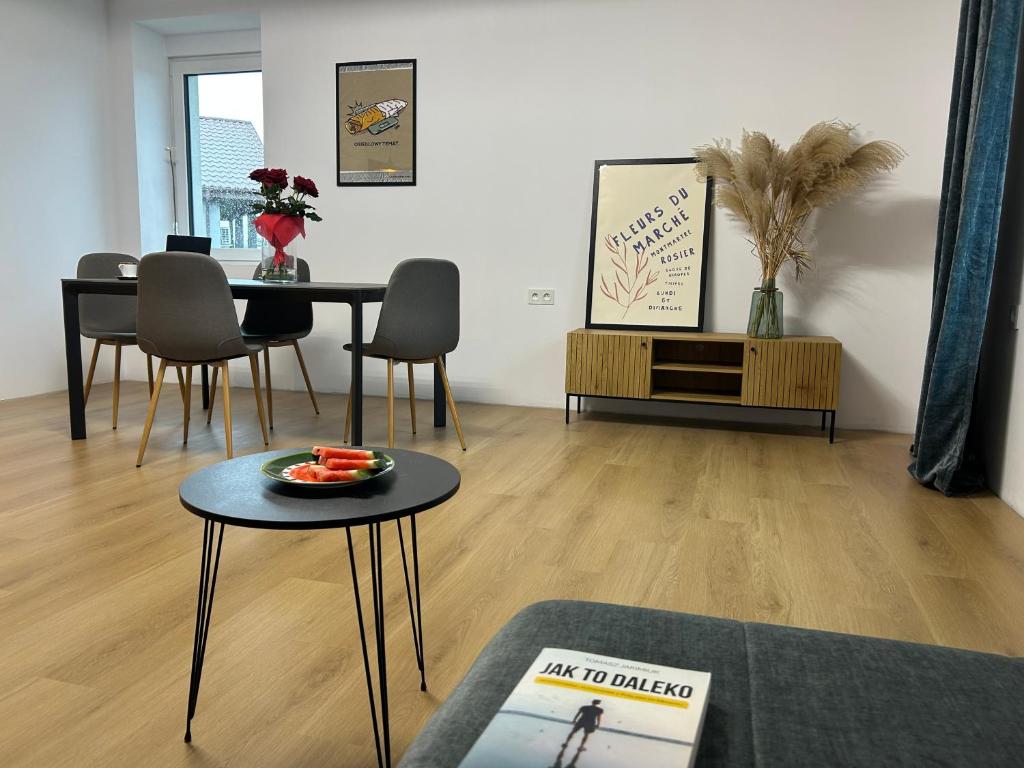 a living room with a table with a plate of fruit on it at Apartamenty Leszczynowa in Łomża