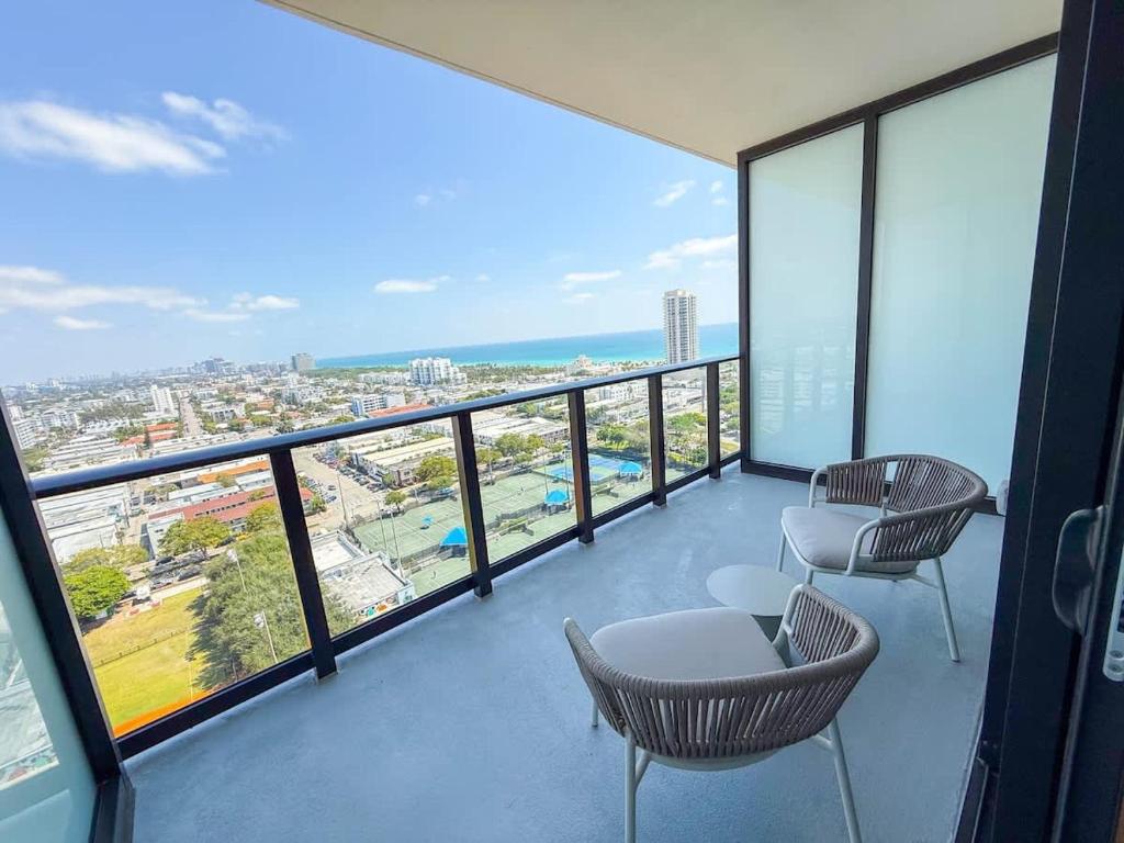 a balcony with chairs and a view of the ocean at Luxury View-Walk to beach! in Miami Beach