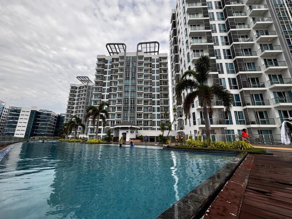 a large swimming pool in front of tall buildings at 8 Newtown Mactan in Pajo