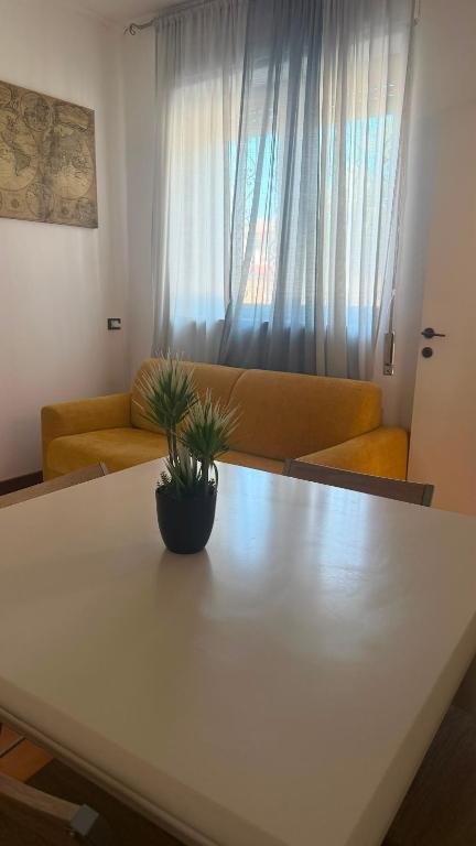 a living room with a table and a couch at Luna in Novara