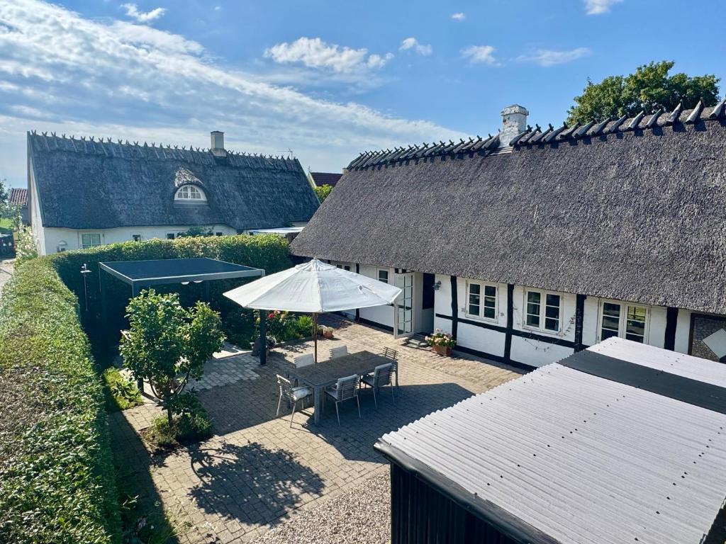 an overhead view of a house with a table and an umbrella at Fred & Lyst in Stenløse