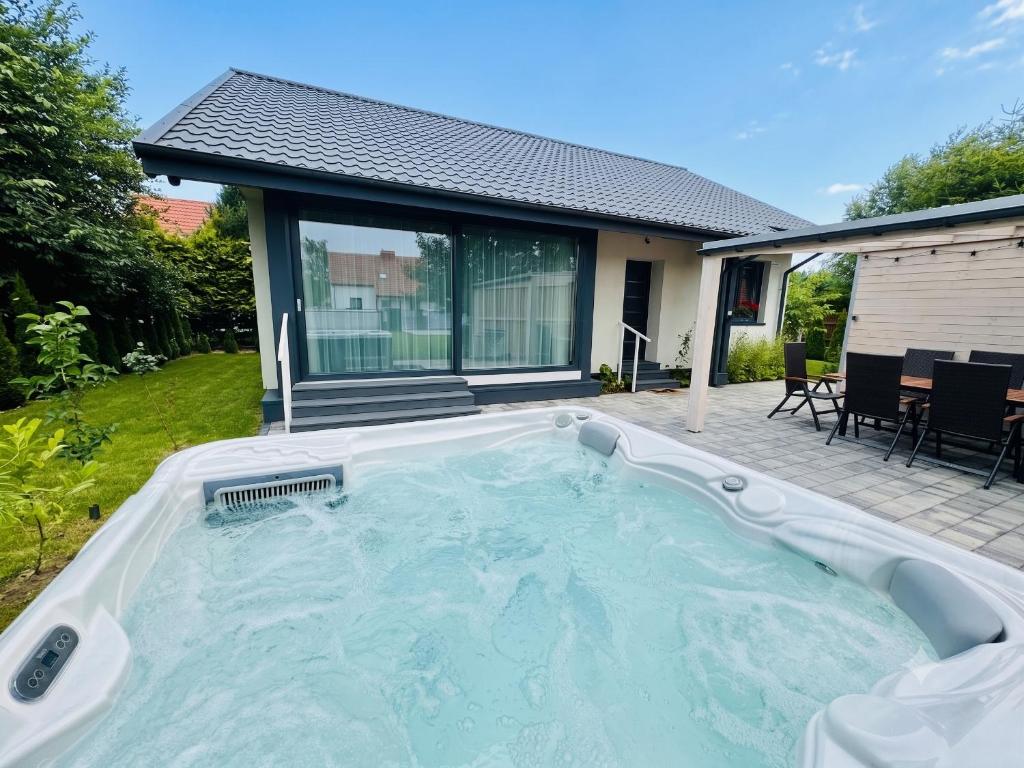 a hot tub in the backyard of a house at Dom Port Orion Puck in Puck