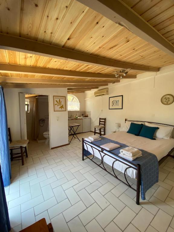 a bedroom with a bed and a wooden ceiling at Studio Apartments in Monemvasia