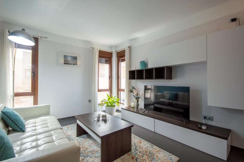 a living room with a couch and a tv at Apartamento rural Castillo de Yeste 2 pax Especial Parejas in Yeste