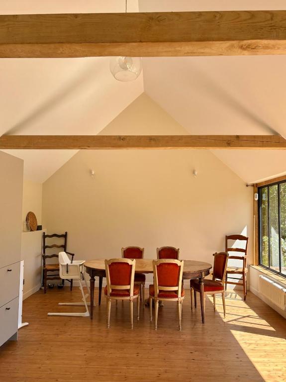 a dining room with a table and chairs at Dreamy Perche landscape in Bivilliers