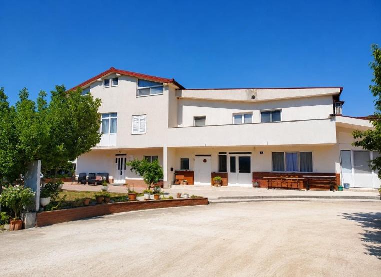 a large white building with a lot of windows at Rooms Ava Raj in Međugorje