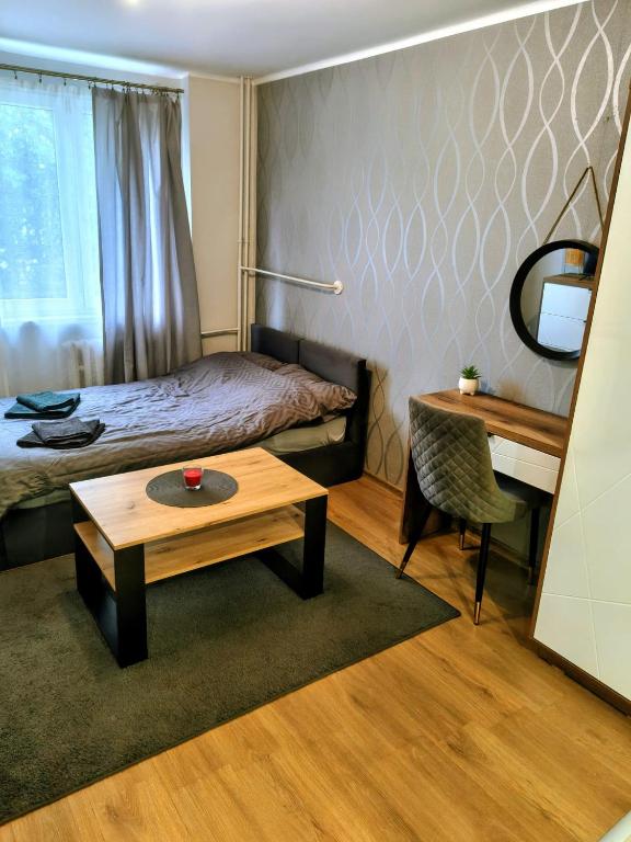 a hotel room with a bed and a table at Na Podwalu in Jaworzno