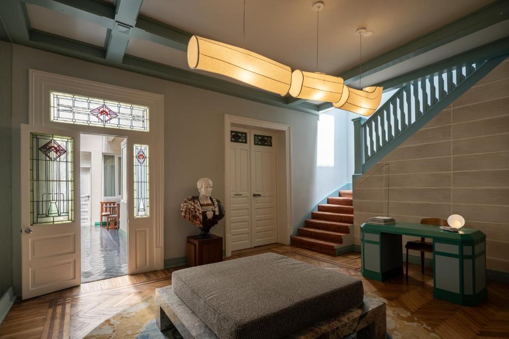 a living room with a staircase and a stair case at Hotel Casa Bosques Pensión in Mexico City