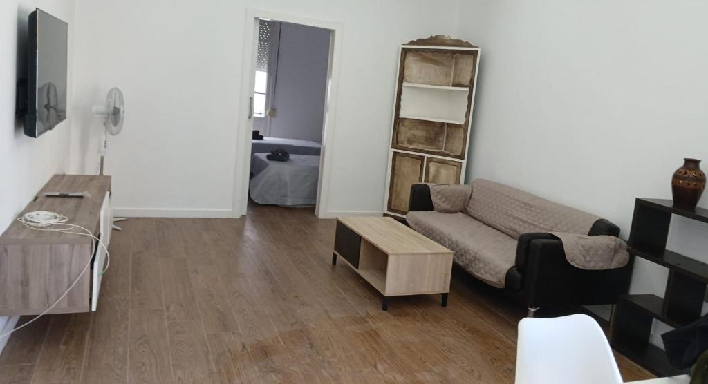 a living room with a couch and a table at Sunny terrace flat in Ceuta