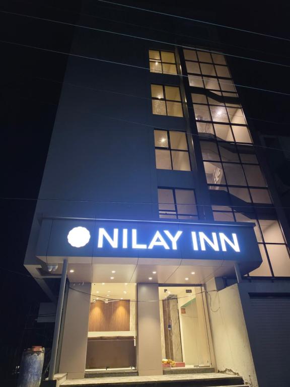 a nilley inn sign in front of a building at NilayInn in Pandharpur