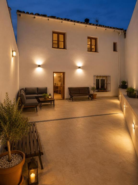 a patio with a couch and a bench in front of a building at EL CHORRO Aire acondicionado Bar privado Barbacoa Amplios patios in Castalla