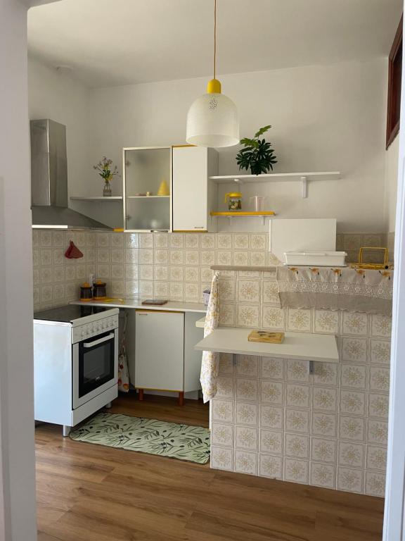 a kitchen with white appliances and a white counter top at ca' de Nardo in Tuoro sul Trasimeno