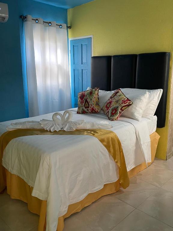 a bedroom with a large bed with white sheets and pillows at Attres in Monkey Hill