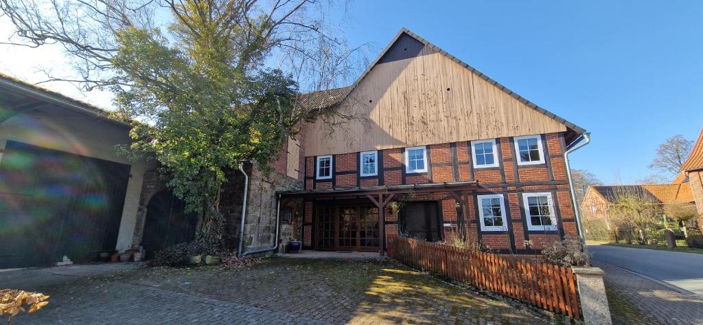 a large brick house with a large door at Dehmkerhof in Aerzen