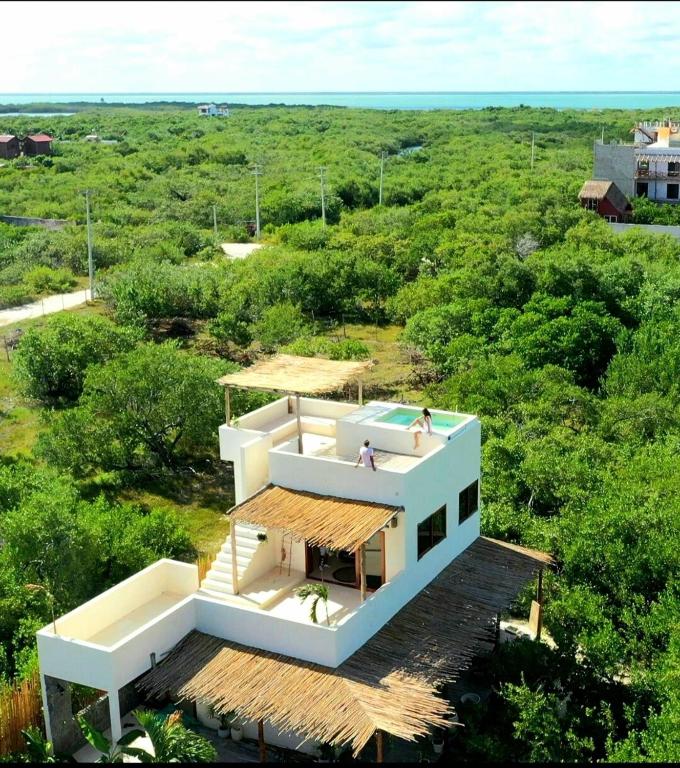 two people standing on the roof of a house at Private luxury villa in Holbox Island