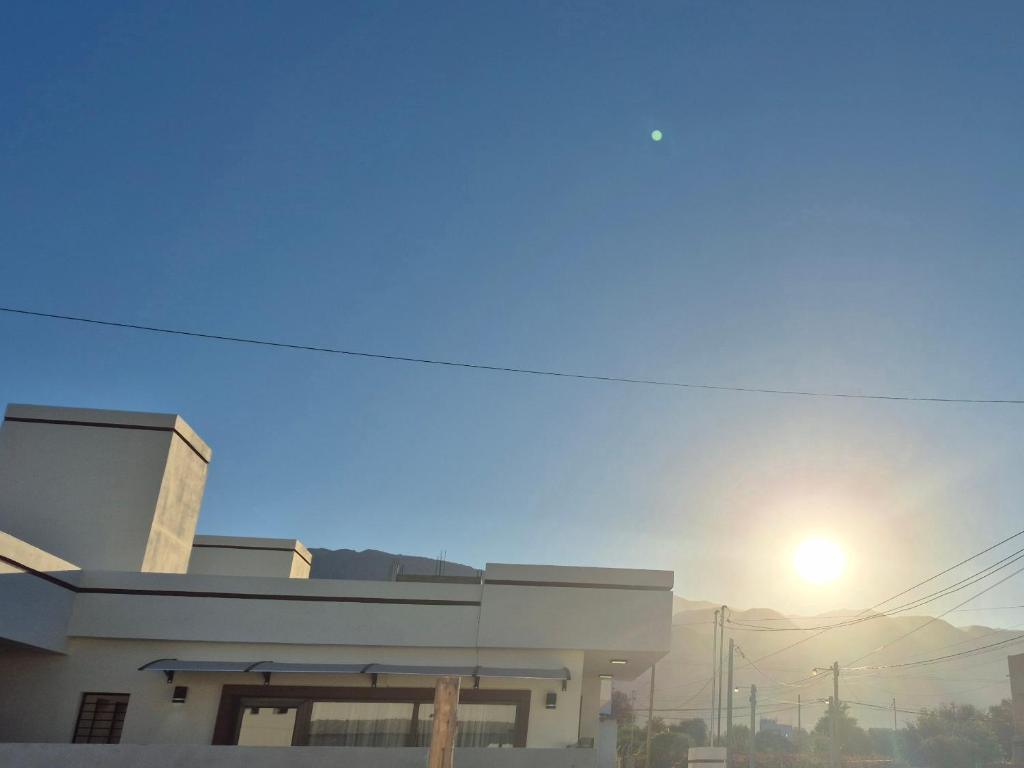 a building with the sun in the sky at El hogarcito in Cafayate