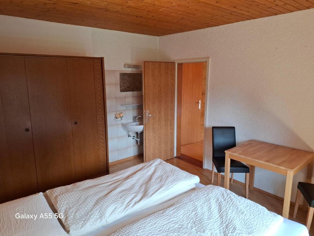 a bedroom with a bed and a desk and a table at Haus Mooswald in Lechleiten