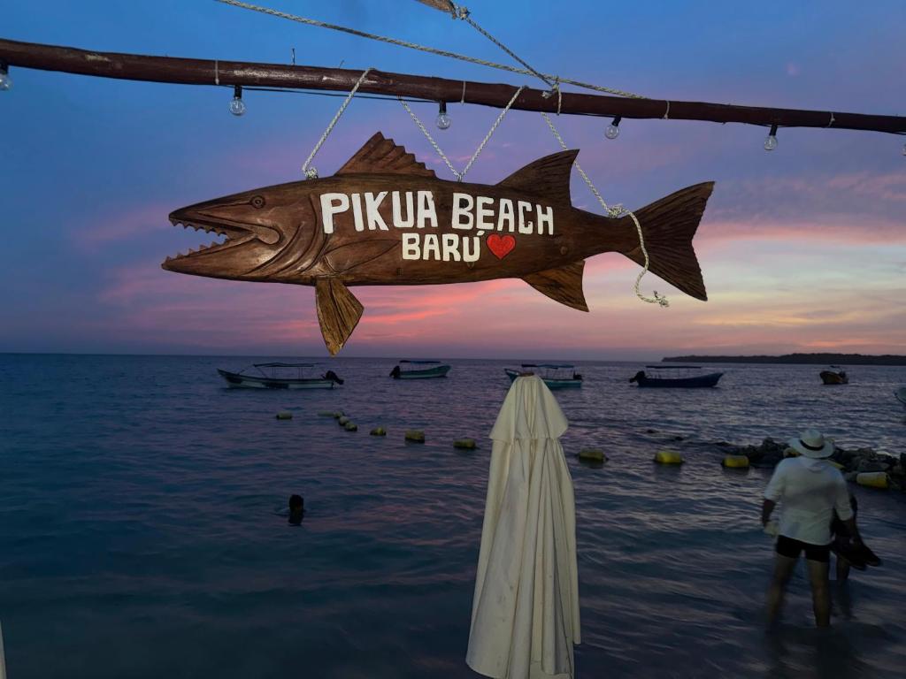 a sign that reads pula beach bar with a fish at Pikua Beach Baru in Playa Blanca