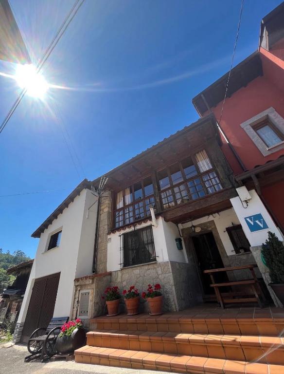 a house with potted plants in front of it at La casina de la Texa in La Sestal