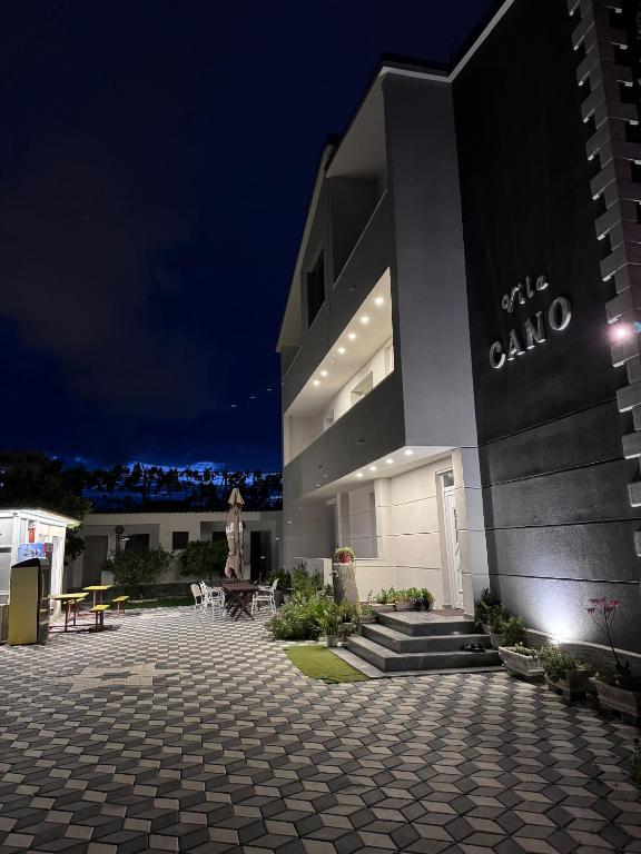 a large building with a courtyard at night at Vila CANO Boutique in Durrës