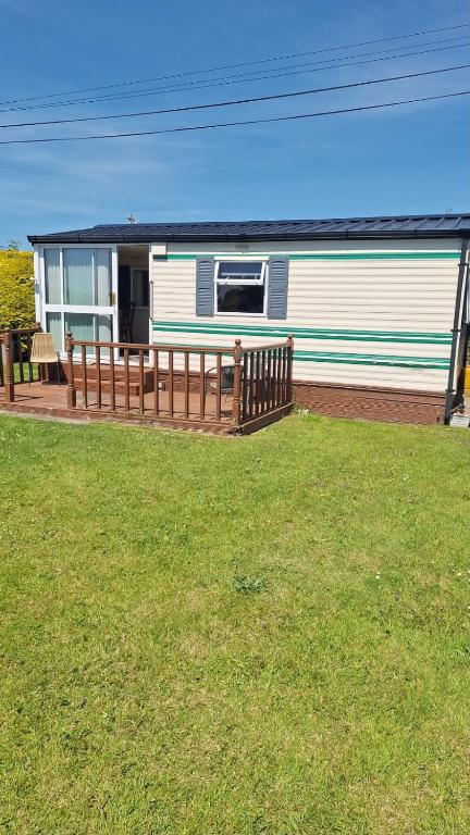 a mobile home with a fence in a yard at Clonvilla Mobile Chalet in Cromponn Bridge