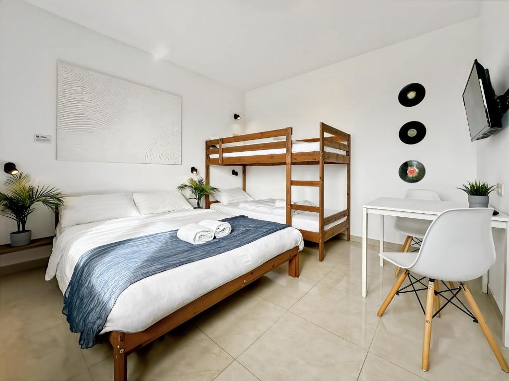 a bedroom with a bed and a desk and a chair at Hatton - 650m do plaży ! in Grzybowo