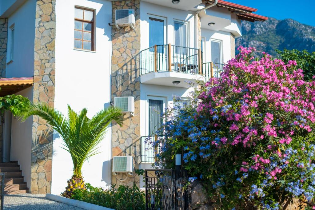 a house with flowers in front of it at Marvera Hotel in Fethiye