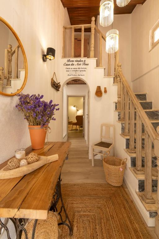 a dining room with a wooden table and stairs at A casa da avó Tina in Montemor-o-Novo