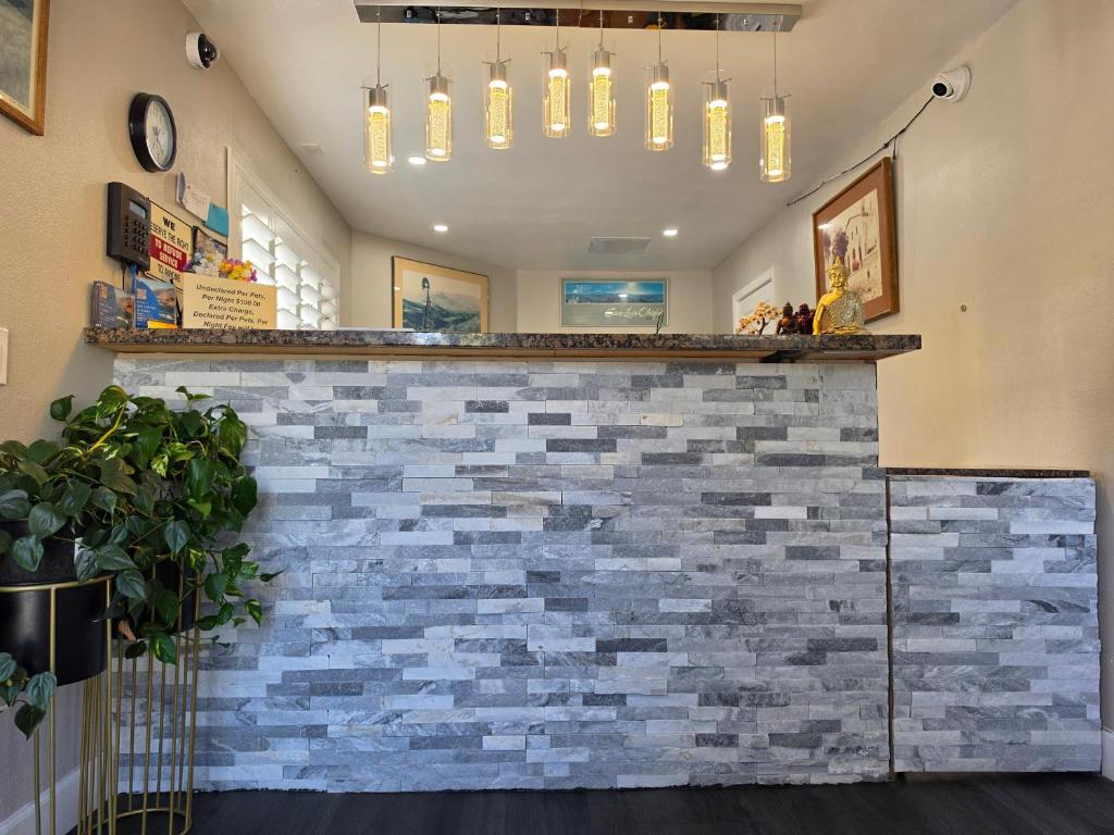 a brick wall with a bar in a room at San Luis Inn and Suites in San Luis Obispo