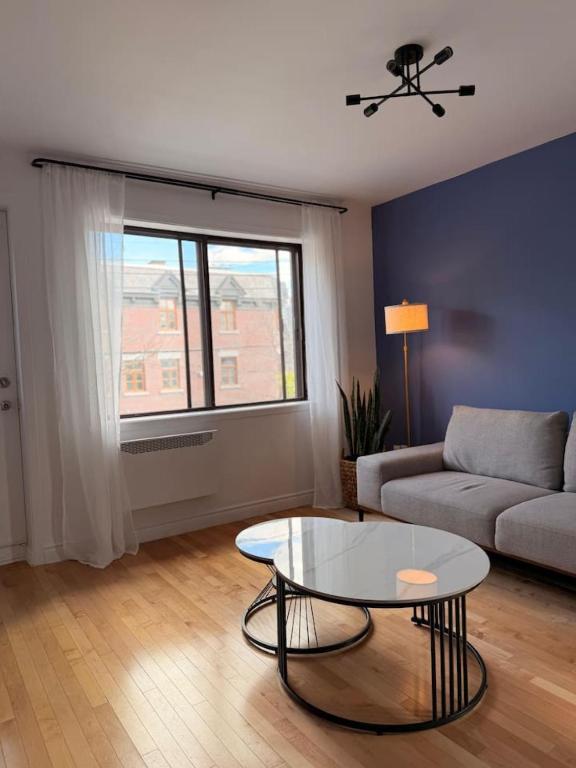 a living room with a couch and a table at Maison Des Jardins B & B in Montreal