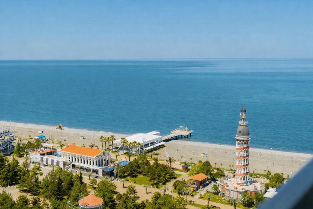 an aerial view of a beach with a clock tower at Orbi City Panoramic Sea View Balcony in Batumi