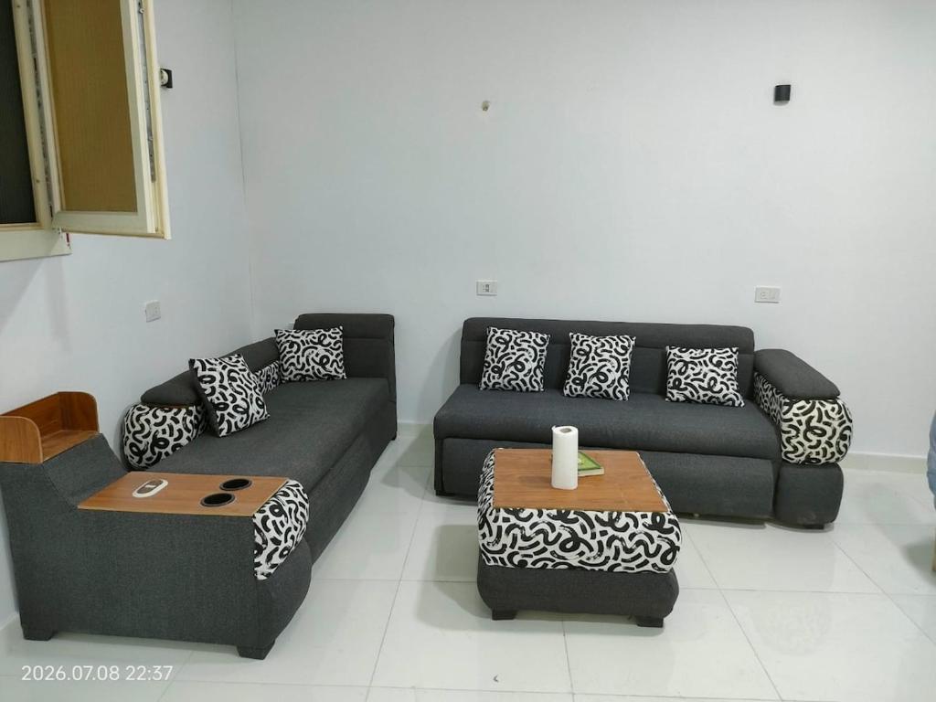 a living room with a couch and a table at Holiday Home Matrouh in Marsa Matruh