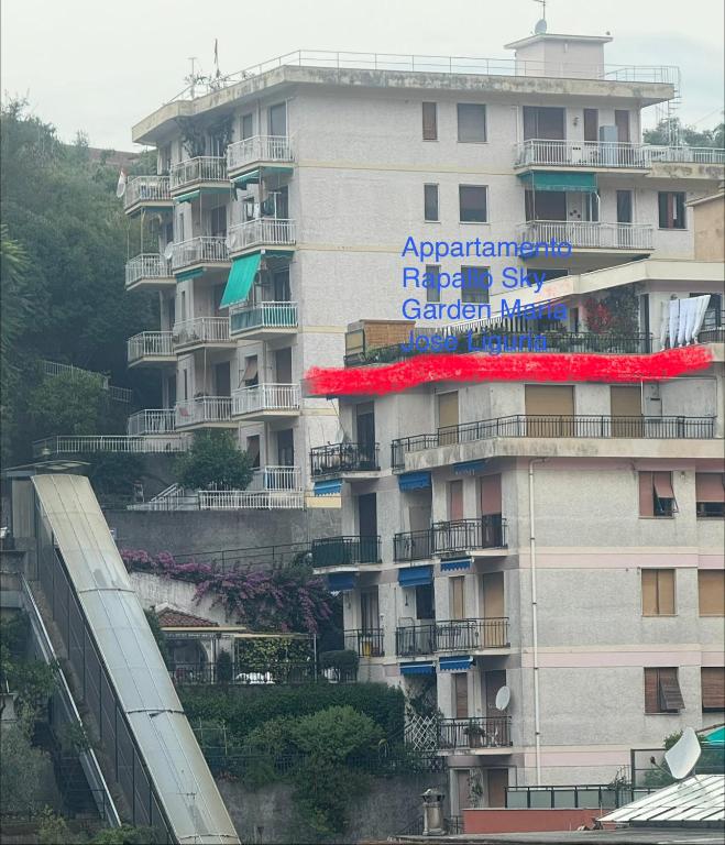 a building with a sign on the side of it at Appartamento Rapallo Sky Garden Maria Jose Liguria - Attico vista mare - Terraces - 2 bagni- 2 Camera da Letto - Box, Wi-fi, Idromassaggio Free inteiro Attico per Voi, con Ascensore in Rapallo