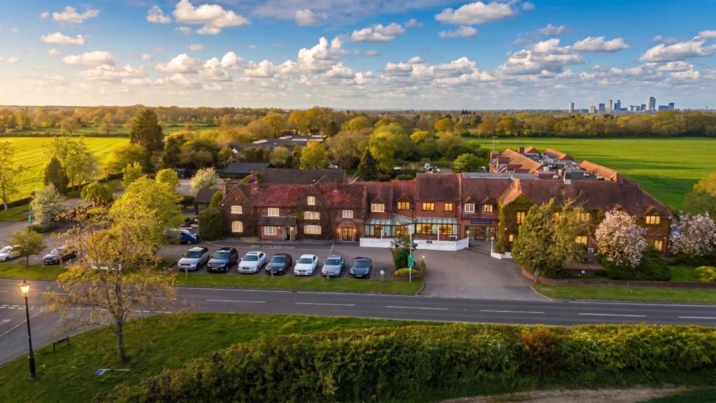 an aerial view of a house with a parking lot at The Warwick Hotel Kenilworth in Kenilworth