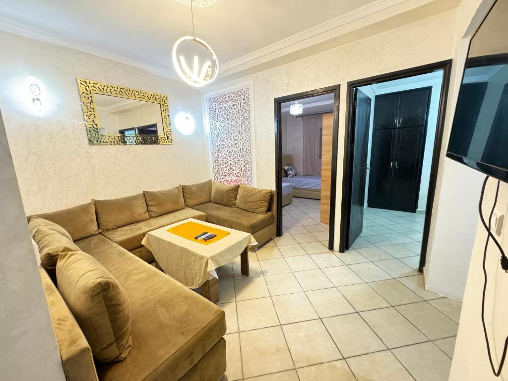 a living room with a couch and a table at Cozy Ajanif Suite in Martil