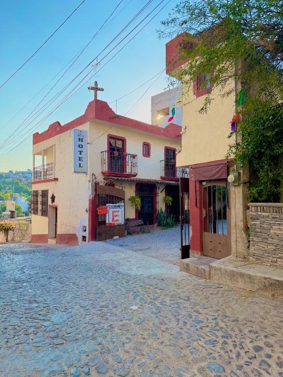 a building on the side of a street at Hotel Casa de Los Abuelos in Bernal