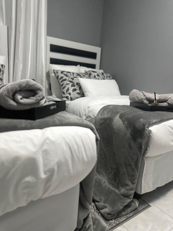 a bedroom with two beds with blankets on them at P Daisy in Rundu