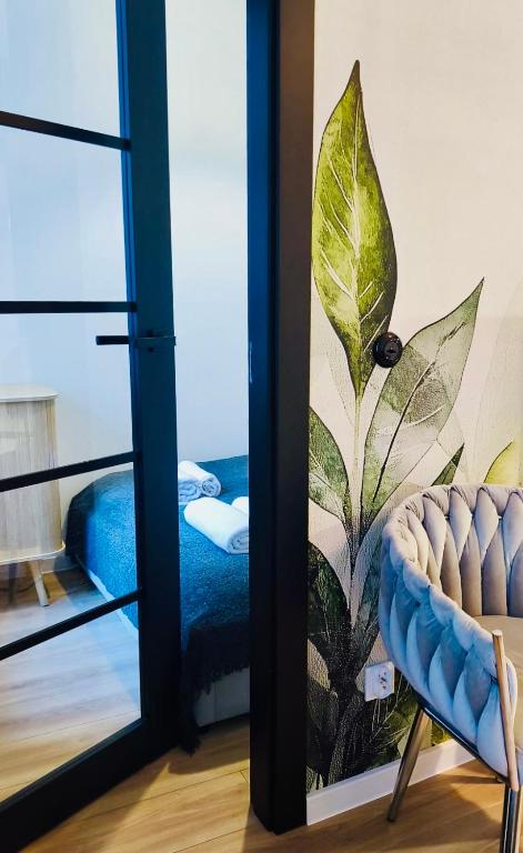 a room with a window with a view of a bedroom at BOOGIE Home Nawrot 13 in Łódź