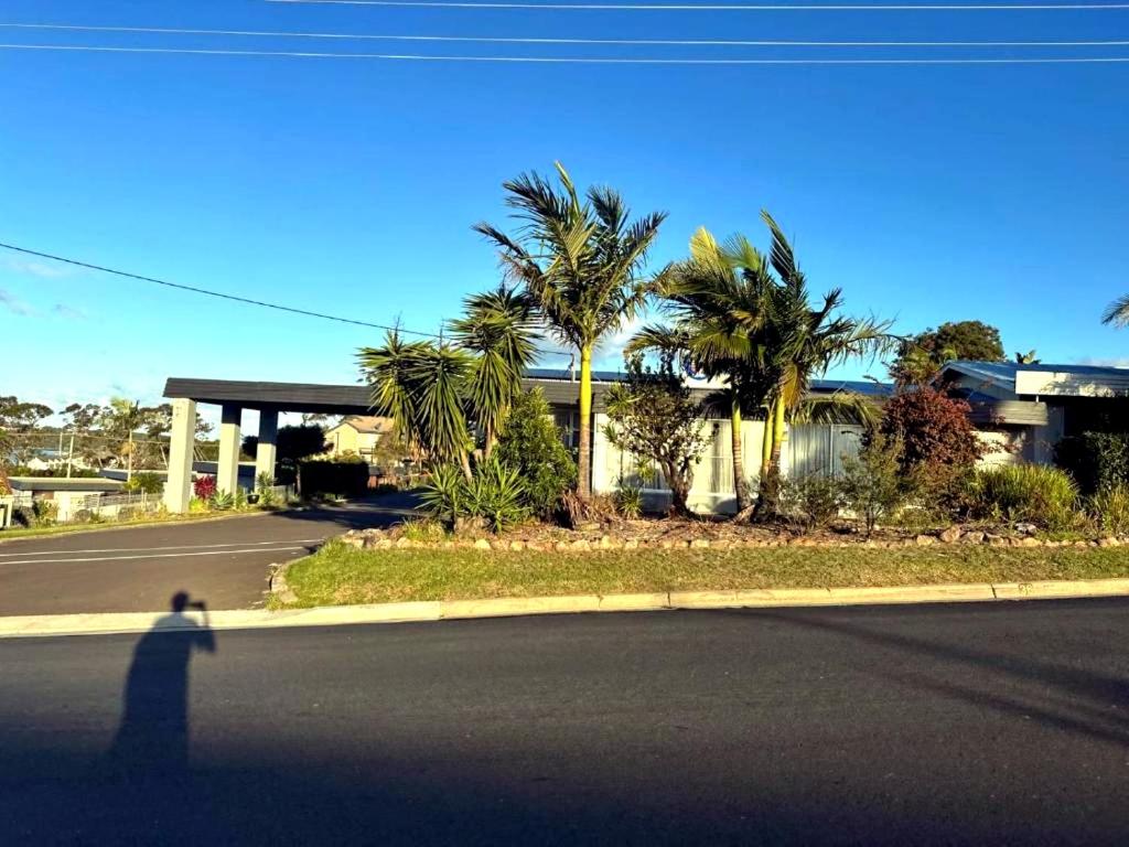 a shadow of a person walking down a street at Merimbula Coastline Motel in Merimbula