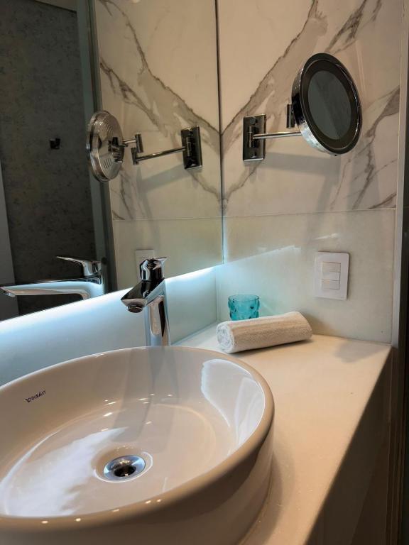 a bathroom with a white sink and a mirror at Icônico Hotel Nacional in Rio de Janeiro