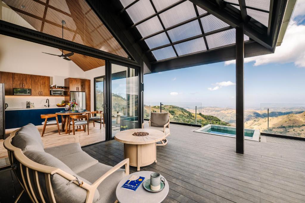 an open living room with a view of the mountains at Lakay Monteverde with Heated Pool, Golf Cart, Breakfast in Monteverde Costa Rica
