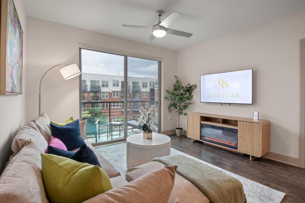 a living room with a couch and a tv at Walk to Toyota Stadium in Frisco